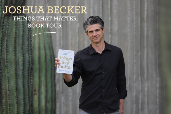 Joshua Becker standing near some Saguaro cacti holding up his book, Things That Matter, in a black button up shirt.